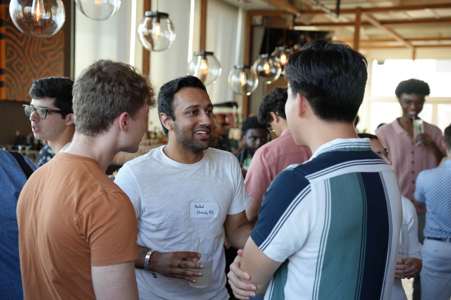 Event photography - networking at upscale venue with warm pendant lighting