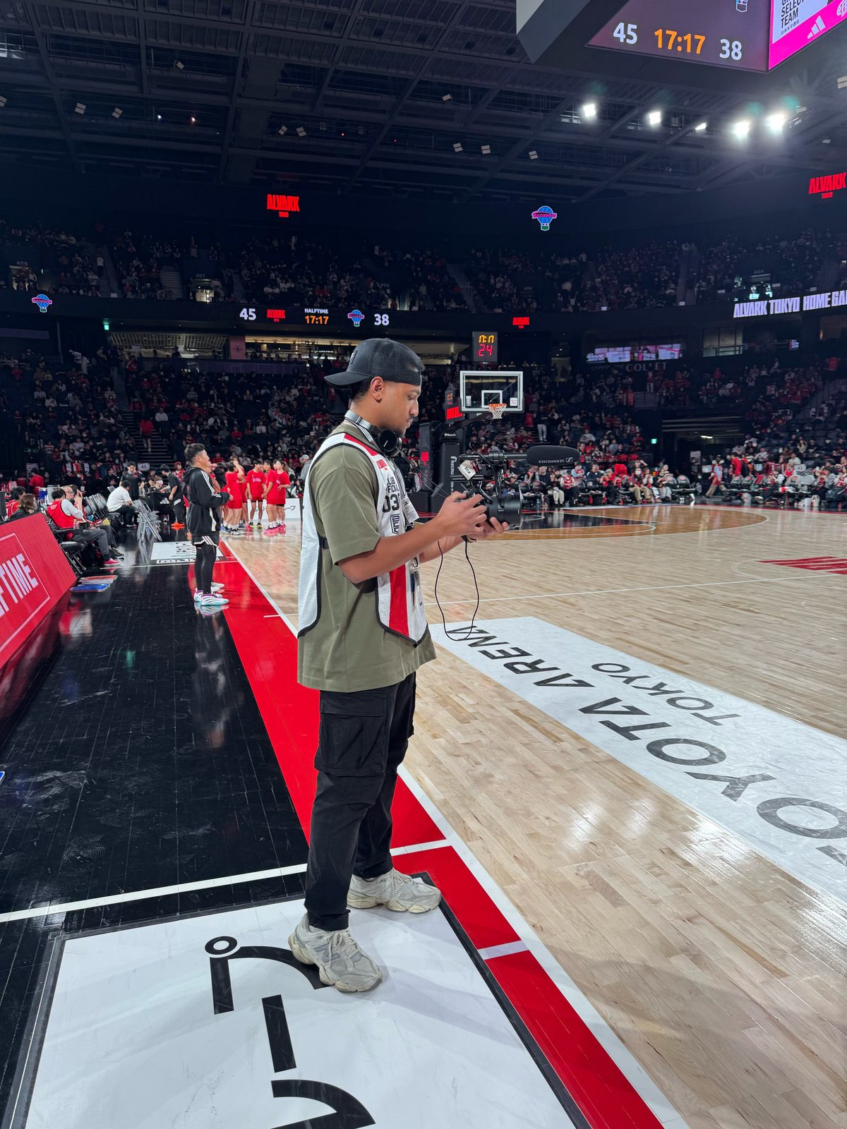 Jamien Petty, founder of Wes Way Creative, courtside with a camera